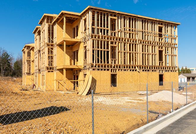 a temporary chain link fence in front of a building under construction, ensuring public safety in Greenwell Springs, LA